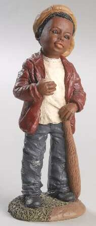 Figurine wearing a red jacket and holding a broomstick.