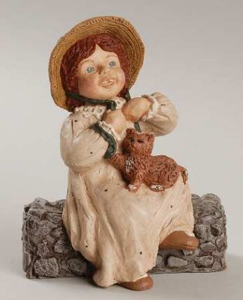 Vintage ceramic figurine of a girl in a straw hat holding a brown dog.