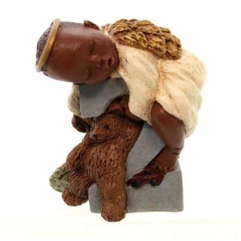 Figurine of a young girl carrying a teddy bear and a bundle of items on her back.