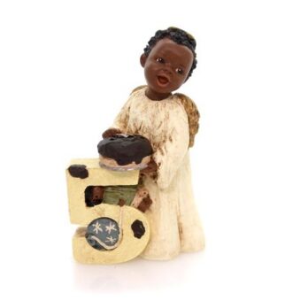 Figurine of a child baking with a vintage stove.
