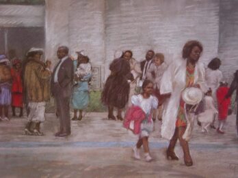 People in traditional clothing walking in a market street.