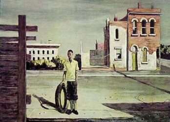 A man stands with a bicycle tire in a quiet urban street scene.