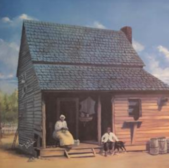 A rustic wooden cabin with a woman and dog outside.