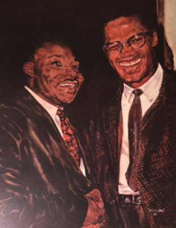 Two men in suits smiling and shaking hands.