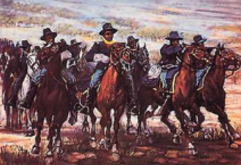 A group of riders charging forward on horseback.